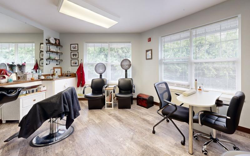 a room with a table chairs and a window